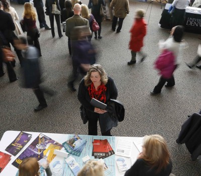 A job seeker talks to an exhibitor at the Colorado Hospital Association health care career fair in Denver